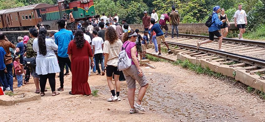 Passengers and onlookers rush to get photographs of the Bridge and train. Photo: Uttara Gangopadhyay