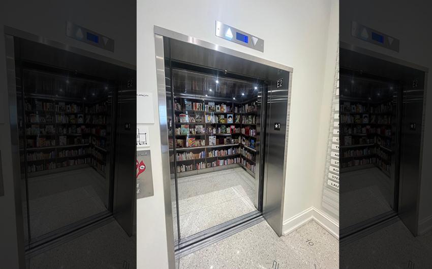 An elevator with shelves full of books.